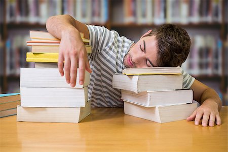 Student asleep in the library against books on desk in library Stock Photo - Budget Royalty-Free & Subscription, Code: 400-08379962