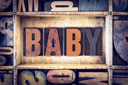The word "Baby" written in vintage wooden letterpress type. Foto de stock - Super Valor sin royalties y Suscripción, Código: 400-08409449