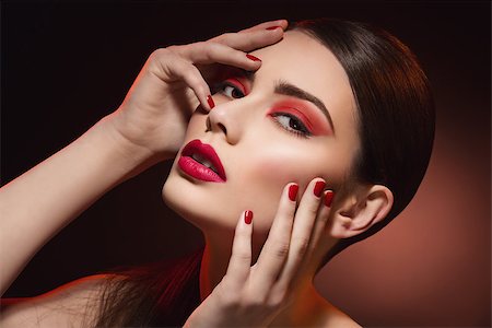 Closeup portrait of beautiful young woman with bright red eyeshadows, lips and nails Stock Photo - Budget Royalty-Free & Subscription, Code: 400-08400867