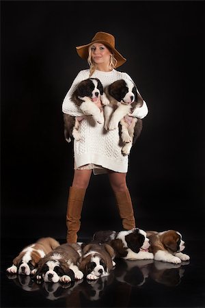 simsearch:400-08402912,k - Young woman with seven puppies on a black studio background Stock Photo - Budget Royalty-Free & Subscription, Code: 400-08401146