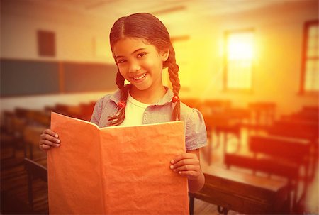 pupil in a empty classroom - Cute pupil smiling at camera during class presentation against empty classroom Stock Photo - Budget Royalty-Free & Subscription, Code: 400-08414380