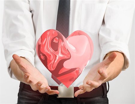 simsearch:400-06100432,k - Red glass heart is flying in hands of young businessman Stock Photo - Budget Royalty-Free & Subscription, Code: 400-08413329