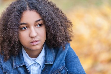 sad african children - Beautiful mixed race African American girl teenager female young woman outside in autumn or fall looking sad depressed or thoughtful Stock Photo - Budget Royalty-Free & Subscription, Code: 400-08430070