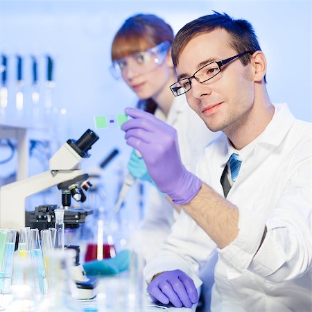 simsearch:400-05669968,k - Young male researcher looking at the microscope slide in the laboratory of biotechnology . Forensics, microbiology, biochemistry, genetics, oncology.. Stock Photo - Budget Royalty-Free & Subscription, Code: 400-08431070