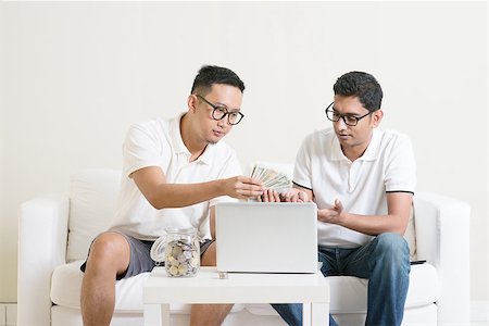 Internet marketing concept. Young guys counting cash with partner, earning money from their successful online business. Asian men working from home. Stock Photo - Budget Royalty-Free & Subscription, Code: 400-08494580