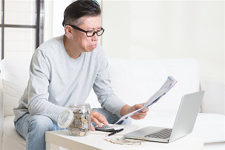 Worried 50s mature Asian man looking at the bills. Saving, retirement, retirees financial planning concept. Stock Photo - Budget Royalty-Free & Subscription, Code: 400-08494622