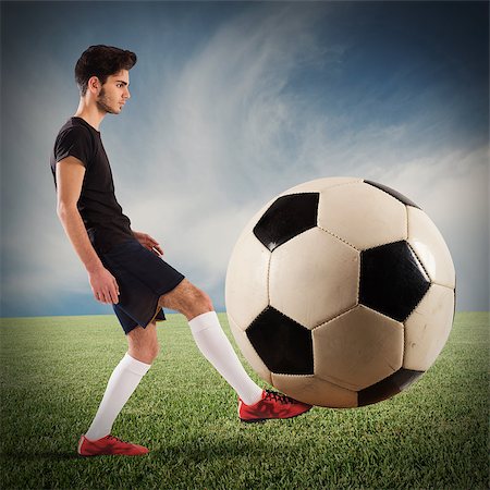 Teenage soccer player plays with big soccerball Stock Photo - Budget Royalty-Free & Subscription, Code: 400-08497650