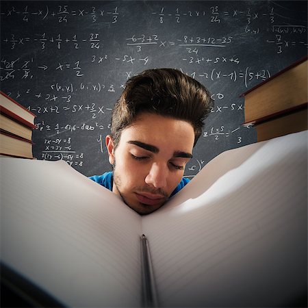 Tired boy asleep in a school notebook Stock Photo - Budget Royalty-Free & Subscription, Code: 400-08491736