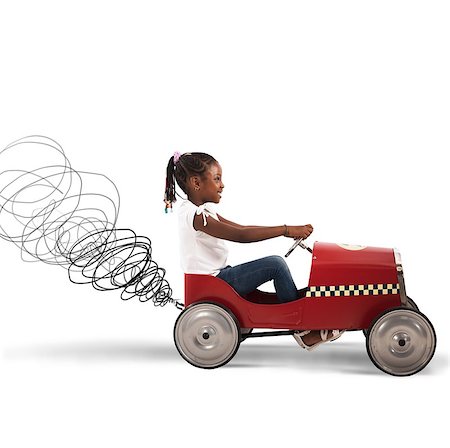 Happy little girl driving a toy car Stock Photo - Budget Royalty-Free & Subscription, Code: 400-08492664