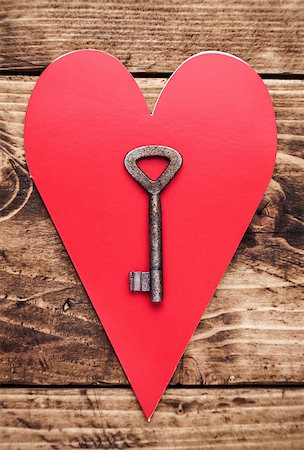 simsearch:400-08034169,k - Love concept. An Old key and a heart on wooden background Stock Photo - Budget Royalty-Free & Subscription, Code: 400-08493256