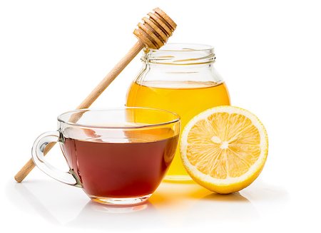 simsearch:400-04273561,k - Black tea in a transparent glass cup honey pot and spoon for honey, lemon closeup isolated on a white background Stock Photo - Budget Royalty-Free & Subscription, Code: 400-08501042