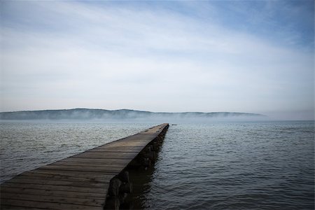 simsearch:400-04756224,k - Morning at the lake. Beautiful old wooden pier and forest hill in background Stock Photo - Budget Royalty-Free & Subscription, Code: 400-08533005