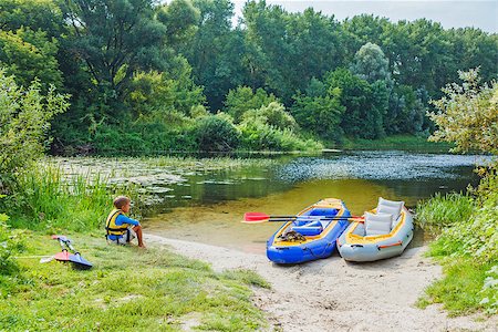 simsearch:400-05308802,k - Active boy resting after adventurous experience kayaking on the river on a sunny day during summer vacation Stock Photo - Budget Royalty-Free & Subscription, Code: 400-08574064