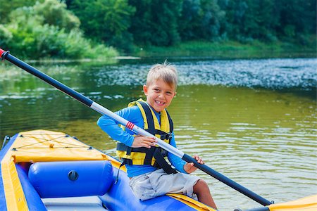 simsearch:400-05308802,k - Active happy child having fun adventurous experience kayaking on the river on a sunny day during summer vacation Stock Photo - Budget Royalty-Free & Subscription, Code: 400-08574065