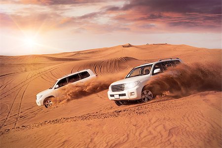 dune driving - two 4x4 vehicles bashing side to side through the desert dunes in the evening sun Stock Photo - Budget Royalty-Free & Subscription, Code: 400-08572929