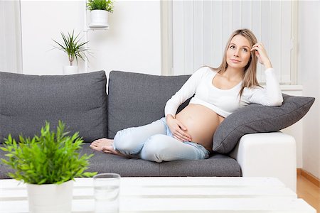 Beautiful pregnant woman relaxing at home on a sofa Stock Photo - Budget Royalty-Free & Subscription, Code: 400-08573018