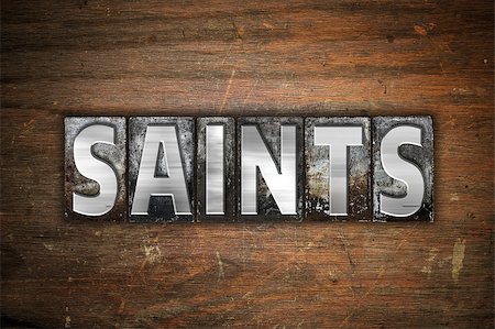 The word "Saints" written in vintage metal letterpress type on an aged wooden background. Stock Photo - Budget Royalty-Free & Subscription, Code: 400-08573091