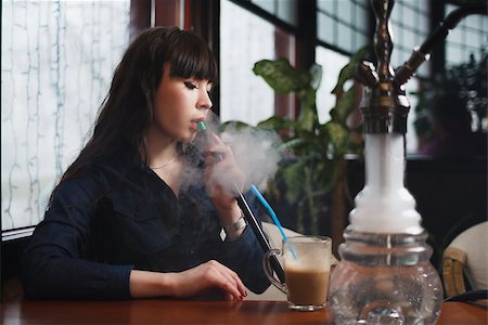 Concept: leisure lifestyle. Beautiful young woman with hookah in a bar restaurant Stock Photo - Budget Royalty-Free & Subscription, Code: 400-08617806