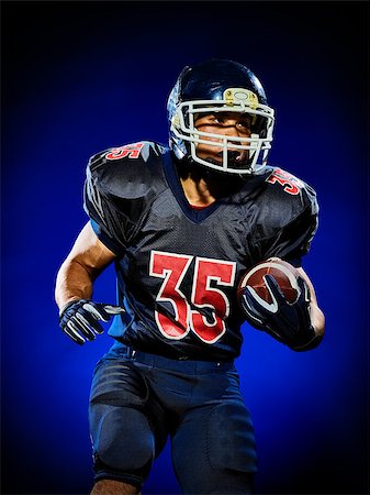 football player action not soccer - one american football player man isolated on colorful black background Stock Photo - Budget Royalty-Free & Subscription, Code: 400-08625500