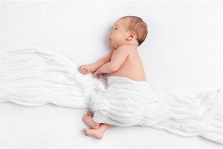 Cute newborn baby lying on bed under a blanket Stock Photo - Budget Royalty-Free & Subscription, Code: 400-08668735