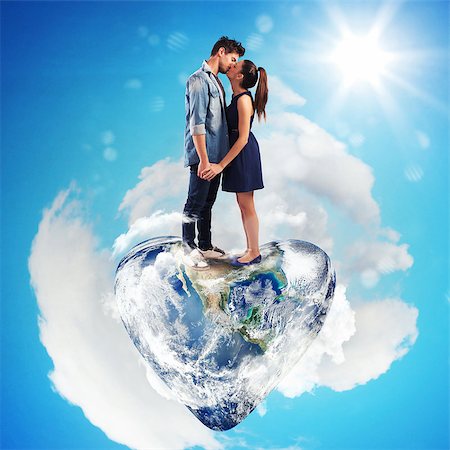 Lovely couple kissing on a heart-shaped world Stock Photo - Budget Royalty-Free & Subscription, Code: 400-08668733