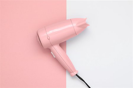 simsearch:600-01112551,k - Pink hair dryer on pink and white paper background Stock Photo - Budget Royalty-Free & Subscription, Code: 400-08675279