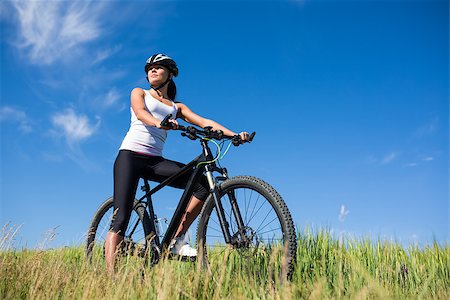girl in helnet rides a bicycle in the countryside. Healsy lifestyle concept. Stock Photo - Budget Royalty-Free & Subscription, Code: 400-08672824
