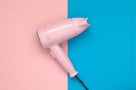 simsearch:600-01112551,k - Pink hair dryer on pink and blue paper background Stock Photo - Budget Royalty-Free & Subscription, Code: 400-08673313