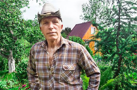 Portraitn senior farmer the background of the house and garden Stock Photo - Budget Royalty-Free & Subscription, Code: 400-08706554