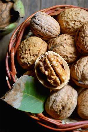 Walnut in basket and whole walnuts on rustic old wood Stock Photo - Budget Royalty-Free & Subscription, Code: 400-08735379