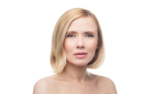 Beautiful middle aged woman with smooth skin and short blond hair. Beauty shot. Isolated over white background. Copy space. Photographie de stock - Aubaine LD & Abonnement, Code: 400-08731480