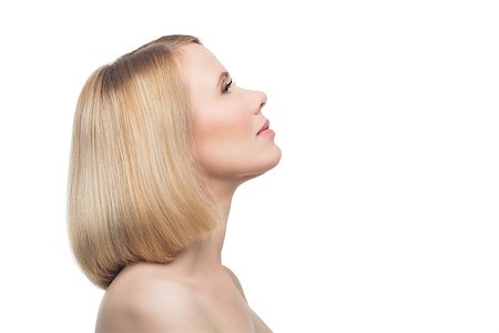 Profile of beautiful middle aged woman with smooth skin and short blond hair. Beauty shot. Isolated over white background. Copy space. Photographie de stock - Aubaine LD & Abonnement, Code: 400-08731482