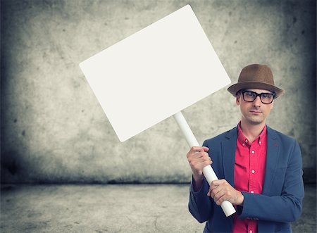 protester holding sign - trendy man holding blank protest sign with copy space Stock Photo - Budget Royalty-Free & Subscription, Code: 400-08731900