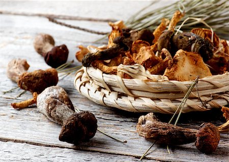 simsearch:400-05738552,k - Arrangement of Forest Dried Mushrooms with Chanterelles, Porcini, Boletus Mushrooms and Dry Stems closeup Rustic Wooden background. Focus on Foreground Stock Photo - Budget Royalty-Free & Subscription, Code: 400-08731929