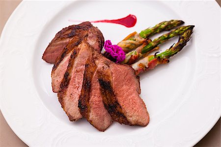 Grilled duck breast with bacon asparagus and raspberry sauce Stock Photo - Budget Royalty-Free & Subscription, Code: 400-08731944