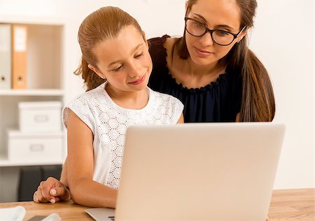 Mother helping her little daughter how to use a computer Stock Photo - Budget Royalty-Free & Subscription, Code: 400-08733025