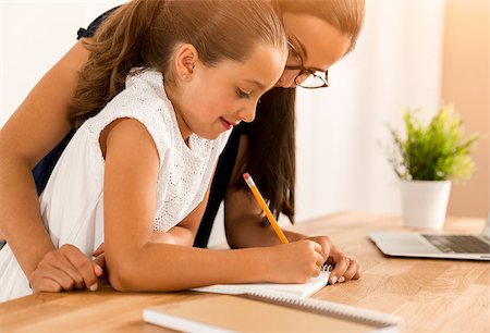 Mother and daugther at home doing homework together Stock Photo - Budget Royalty-Free & Subscription, Code: 400-08733027