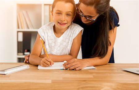 Mother and daugther at home doing homework together Stock Photo - Budget Royalty-Free & Subscription, Code: 400-08733028
