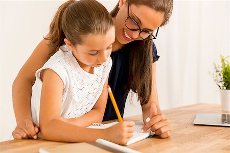 Mother and daugther at home doing homework together Stock Photo - Budget Royalty-Free & Subscription, Code: 400-08733029