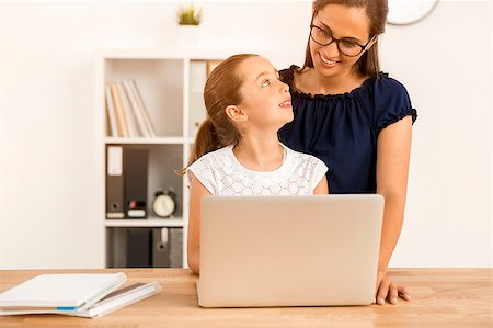Mother helping her little daughter how to use a computer Stock Photo - Budget Royalty-Free & Subscription, Code: 400-08733023