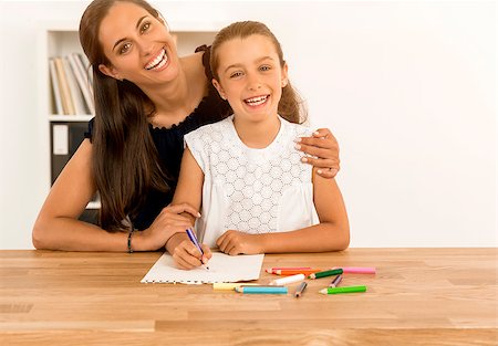 Mother helping her little daughter making drawings Stock Photo - Budget Royalty-Free & Subscription, Code: 400-08733034