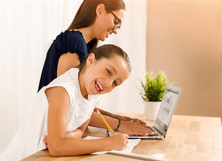 Mother and daugther at home doing homework together Stock Photo - Budget Royalty-Free & Subscription, Code: 400-08733031