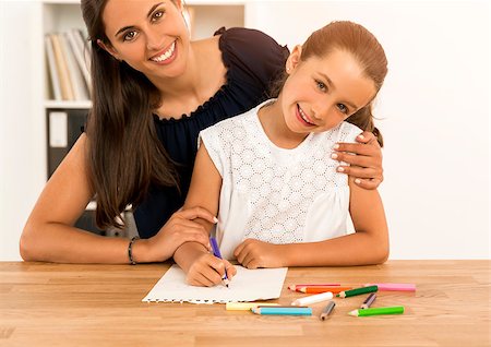 Mother helping her little daughter making drawings Stock Photo - Budget Royalty-Free & Subscription, Code: 400-08733033