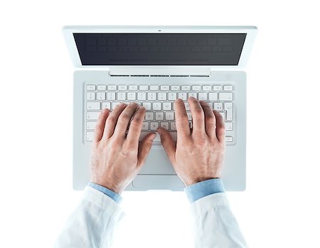 Doctor at desk working at laptop on white background, healthcare and prevention concept, top view Stock Photo - Budget Royalty-Free & Subscription, Code: 400-08749657