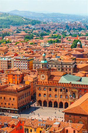 emilia - Italy Piazza Maggiore in Bologna old town tower of town hall with big clock and blue sky on background, antique buildings terracotta galleries Stock Photo - Budget Royalty-Free & Subscription, Code: 400-08754382