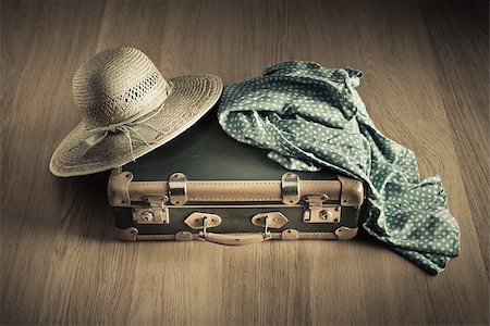 suitcase old - Holiday packing with vintage suitcase and polka dot clothing on hardwood floor. Stock Photo - Budget Royalty-Free & Subscription, Code: 400-08753421