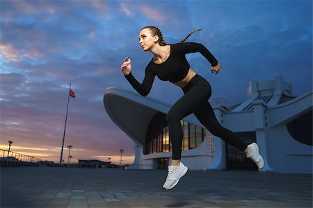 Concept: healthy lifestyle, sport. Attractive happy girl fitness trainer run outdoor workout at modern downtown urban area during sunset. Stock Photo - Budget Royalty-Free & Subscription, Code: 400-08753544