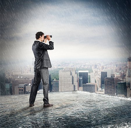 Businessman looks at the city from the roof with binoculars Stock Photo - Budget Royalty-Free & Subscription, Code: 400-08774375