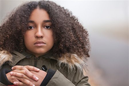 sad african children - Beautiful mixed race African American girl teenager female young woman outside in autumn or fall mist or fog looking sad depressed or thoughtful Stock Photo - Budget Royalty-Free & Subscription, Code: 400-08775245