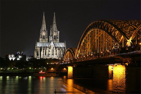 Cologne, Germany - October 16, 2013. Beautiful night view of the Cologne Cathedral and the bridge over the river. Golden lights reflected in the water. And no one around. Stock Photo - Budget Royalty-Free & Subscription, Code: 400-08787418